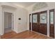 Inviting foyer with hardwood floors and decorative glass front doors at 627 Belted Kingfisher N Dr, Palm Harbor, FL 34683