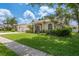 Charming single-story home with well-manicured lawn and mature landscaping at 627 Belted Kingfisher N Dr, Palm Harbor, FL 34683