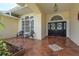 Cozy front porch with tiled flooring and decorative seating area at 627 Belted Kingfisher N Dr, Palm Harbor, FL 34683