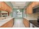 Bright eat-in kitchen with stainless steel appliances, wood cabinets, white countertops, and great natural light at 627 Belted Kingfisher N Dr, Palm Harbor, FL 34683