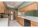 Spacious kitchen with light wood cabinets, tile backsplash, stainless steel appliances and white countertops at 627 Belted Kingfisher N Dr, Palm Harbor, FL 34683