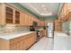 Modern kitchen with white countertops, stainless steel appliances, and ample cabinet space at 627 Belted Kingfisher N Dr, Palm Harbor, FL 34683