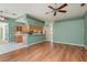 Open-concept living space with wood floors and view to the kitchen, enhancing the home's appeal at 627 Belted Kingfisher N Dr, Palm Harbor, FL 34683