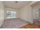 Bright living room with neutral carpet and sliding door access to the pool area at 627 Belted Kingfisher N Dr, Palm Harbor, FL 34683