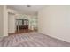 Spacious living room featuring neutral carpet and a beautiful entryway with a decorative glass door at 627 Belted Kingfisher N Dr, Palm Harbor, FL 34683