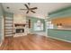 Inviting living room with a stone fireplace, built-in shelves, and an open view to the kitchen at 627 Belted Kingfisher N Dr, Palm Harbor, FL 34683