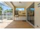 Outdoor patio with built-in kitchen and barbecue area, ceiling fan, and access to pool and spa at 627 Belted Kingfisher N Dr, Palm Harbor, FL 34683