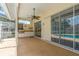 Outdoor patio with built-in kitchen and barbecue area, ceiling fan, and access to pool and spa at 627 Belted Kingfisher N Dr, Palm Harbor, FL 34683