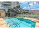 Screened-in pool with heated spa and a deck for outdoor entertaining at 627 Belted Kingfisher N Dr, Palm Harbor, FL 34683