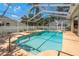 Screened-in pool with heated spa and a deck for outdoor entertaining at 627 Belted Kingfisher N Dr, Palm Harbor, FL 34683