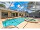Screened-in pool with heated spa and a deck for outdoor entertaining at 627 Belted Kingfisher N Dr, Palm Harbor, FL 34683