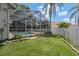 Backyard view featuring a sparkling pool and surrounding landscaping providing a serene outdoor retreat at 627 Belted Kingfisher N Dr, Palm Harbor, FL 34683