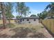 Backyard with patio features a wooden fence and mature trees at 6347 S Lansdale Cir, Tampa, FL 33616