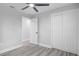 Light bedroom features wood-look flooring, ceiling fan, and a closet for storage at 6347 S Lansdale Cir, Tampa, FL 33616