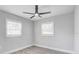 Bedroom features wood-look flooring, two windows, and neutral paint at 6347 S Lansdale Cir, Tampa, FL 33616