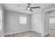 Bedroom featuring a ceiling fan, window, closet and light gray wood-look flooring at 6347 S Lansdale Cir, Tampa, FL 33616