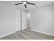 Bright bedroom with wood-look flooring, ceiling fan, and closet for storage at 6347 S Lansdale Cir, Tampa, FL 33616