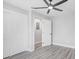 Bedroom featuring a ceiling fan, closet, and light gray wood-look flooring at 6347 S Lansdale Cir, Tampa, FL 33616