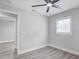 This well lit bedroom boasts wood-look flooring and a ceiling fan at 6347 S Lansdale Cir, Tampa, FL 33616