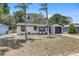 Charming single-story home with well-maintained landscaping, dark trim, and a one-car garage at 6347 S Lansdale Cir, Tampa, FL 33616