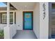 Close-up of a bright blue front door with modern hardware and contrasting trim at 6347 S Lansdale Cir, Tampa, FL 33616