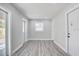 Hallway with doors leading to other rooms and light gray wood-look flooring at 6347 S Lansdale Cir, Tampa, FL 33616