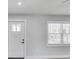 Bright interior showing the front door, window with blinds, and neutral decor at 6347 S Lansdale Cir, Tampa, FL 33616