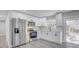 Updated kitchen with stainless steel appliances, white cabinets, and vinyl flooring at 6347 S Lansdale Cir, Tampa, FL 33616