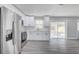 Bright kitchen with stainless steel appliances, white cabinets, and sliding doors to the backyard at 6347 S Lansdale Cir, Tampa, FL 33616