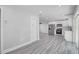 Open-concept living area connects to the modern kitchen with gray wood-look flooring throughout at 6347 S Lansdale Cir, Tampa, FL 33616
