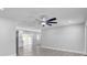 Spacious living room with stylish ceiling fan, new flooring, and lots of natural light at 6347 S Lansdale Cir, Tampa, FL 33616