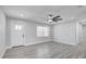 Bright living room featuring new vinyl flooring, a ceiling fan, and a modern interior door at 6347 S Lansdale Cir, Tampa, FL 33616