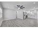 Open-concept living room and kitchen with modern flooring and stainless steel appliances at 6347 S Lansdale Cir, Tampa, FL 33616