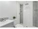 Modern bathroom features a stylish tile shower with a rainfall shower head and glass shelves at 7110 Bonito St, Tampa, FL 33617