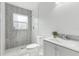Bathroom featuring marble flooring, a walk-in shower with grey tile, and a vanity at 7110 Bonito St, Tampa, FL 33617