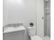 Bathroom with a walk-in shower, white walls, and a sink at 7110 Bonito St, Tampa, FL 33617