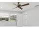 Bedroom with a view to the outside, featuring a ceiling fan, and white walls at 7110 Bonito St, Tampa, FL 33617