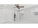 Bedroom with a ceiling fan, marble tiled floors, and a double-door closet at 7110 Bonito St, Tampa, FL 33617