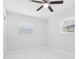 Bedroom featuring marble-look flooring, white walls, and a ceiling fan at 7110 Bonito St, Tampa, FL 33617