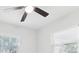 Bedroom featuring a ceiling fan with light and two windows at 7110 Bonito St, Tampa, FL 33617