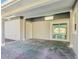 The covered patio features a sliding door and an overhead light, providing access and functionality at 7110 Bonito St, Tampa, FL 33617