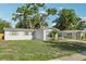 Single-story home with a well-manicured lawn and a covered carport at 7110 Bonito St, Tampa, FL 33617