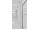 Hallway featuring light walls, marble floors, and an open doorway to a living space at 7110 Bonito St, Tampa, FL 33617