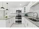 Bright kitchen features white cabinets, stainless steel appliances, and granite countertops at 7110 Bonito St, Tampa, FL 33617