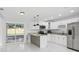 Bright kitchen features white cabinets, stainless steel appliances, and granite countertops at 7110 Bonito St, Tampa, FL 33617
