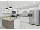 Beautiful kitchen featuring modern appliances, granite counters, and white cabinets at 7110 Bonito St, Tampa, FL 33617