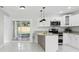Modern kitchen featuring stainless steel appliances, granite countertops, and ample natural light at 7110 Bonito St, Tampa, FL 33617