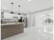 Bright kitchen with stainless appliances, and granite countertops, opening to the living area at 7110 Bonito St, Tampa, FL 33617