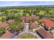 Beautiful aerial view of the complex featuring lush landscaping, lake, and meticulously maintained golf course at 8103 Bardmoor Pl # 203G, Seminole, FL 33777