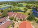 Overhead view of the neighborhood showcasing the community's proximity to a golf course and tranquil ponds at 8103 Bardmoor Pl # 203G, Seminole, FL 33777